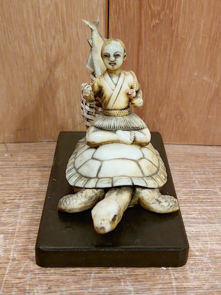 Bakelit-Figur, Mann auf Schildkröte  - Japan - Mitte 20. Jahrhundert